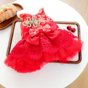 Detail view of red Chinese New Year pet dress with gold floral brocade and fur collar