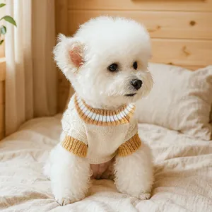 Close-up of thick cable knit texture and striped ribbed collar on cream pet sweater