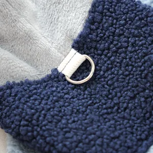 Detail of navy sherpa fleece dog jacket with reinforced webbing and metal D-ring leash attachment
