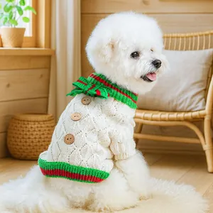Detail of dog knit sweater featuring diamond texture and festive red and green accents