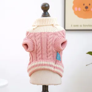 Close-up of pink knit dog sweater featuring cable patterns and ribbed turtleneck collar