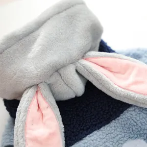 Detail shot of plush grey bunny ears with pink lining on a fuzzy pet fleece jacket