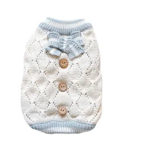 White diamond-knit pet sweater with light blue striped trim and three vintage wooden buttons