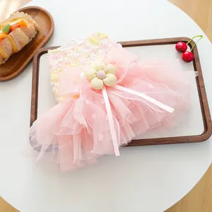 Detailed close-up of pink dog tutu dress featuring fluffy multi-layer mesh and cute flower accent.