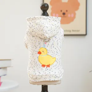 Detail of white hooded pet sweatshirt with yellow duck embroidery and metal D-ring