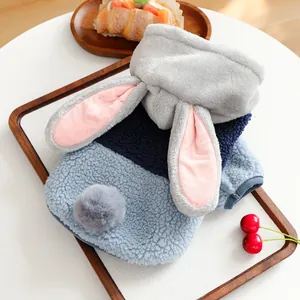 Detail of soft fleece pet hoodie with cute bunny ears and a plush pompom tail