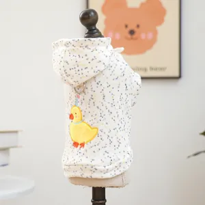 Close-up of cute yellow duck embroidery and traction ring on white pet hoodie