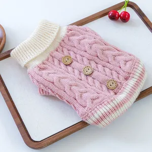 Detailed cable knit pet sweater with decorative wooden buttons and pink striped collar