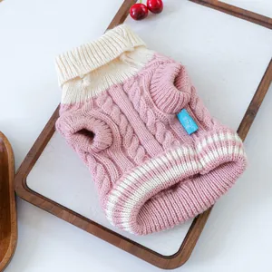 Close-up of pink and cream cable knit pet sweater with warm turtleneck detail