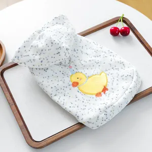 Detailed view of duck embroidery and metal D-ring on a white hooded pet sweatshirt