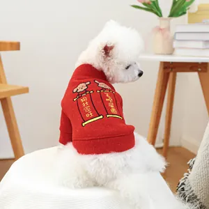 Detail of red festive pet sweater featuring humorous Chinese New Year embroidery