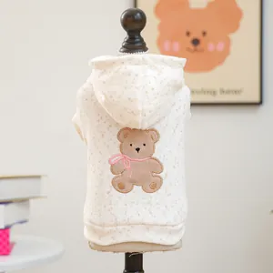 Detailed bear embroidery on cream hooded pet sweatshirt featuring a pink bow tie detail