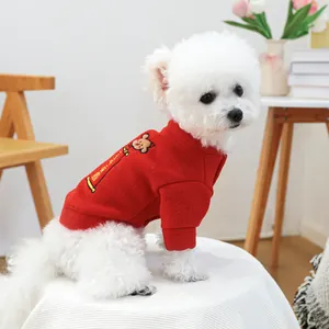 Detail of red festive pet sweater with cute cartoon embroidery for dogs and cats