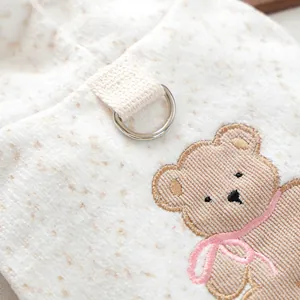 Macro detail of pet sweatshirt featuring a metallic D-ring and cute bear embroidery
