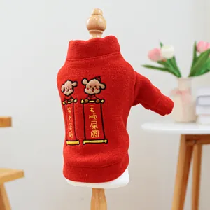 Detail of red pet sweater with festive cartoon dog embroidery on a wooden model