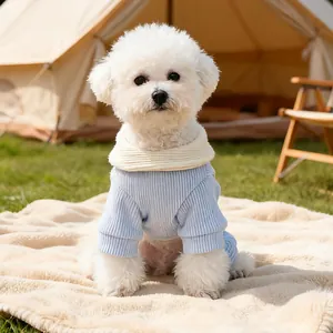 Blue ribbed knit pet jumpsuit with cream high collar for small dogs in a camping setting