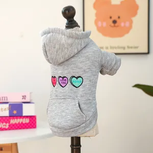 Detail of grey pet hoodie with heart embroidery and functional back pocket for dogs