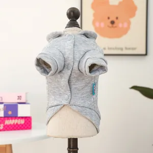 Detail of grey hooded pet sweater with button closure and soft knit texture on dog model