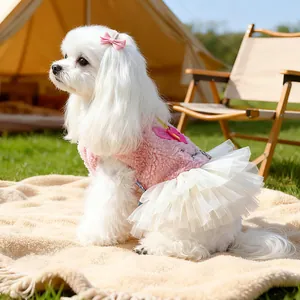 Pink plush unicorn dog dress with white tulle skirt and bow for small pets outdoors