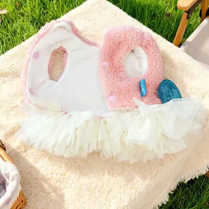 Close-up of pink plush pet dress with multilayer white tulle skirt and snap buttons