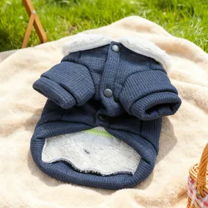 Detail of dark blue quilted pet jacket with warm white fleece lining and grey buttons