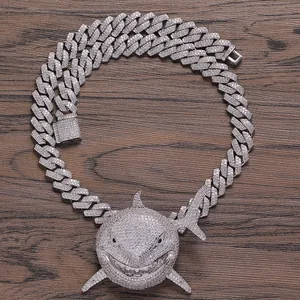 Detailed macro view of hip hop shark pendant with paved zircons on Cuban link chain