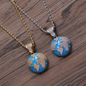 Detail of hip hop blue globe pendants with iced out zircons in gold and silver finishes