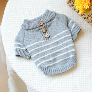 Detail of gray striped pet sweater with wooden buttons and ribbed knitting texture