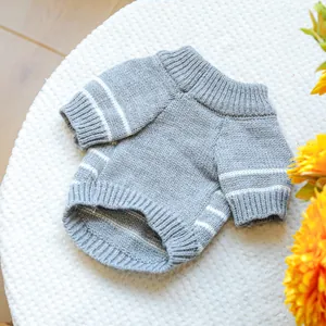 Detailed close-up of grey striped pet sweater with knitted ribbed cuffs and hem