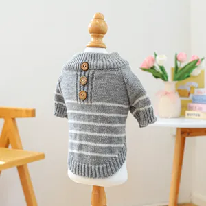 Detail of grey striped pet sweater with wooden buttons on soft knit fabric