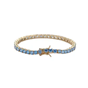 Classic gold tennis bracelet featuring round cut light blue zircon stones on white background