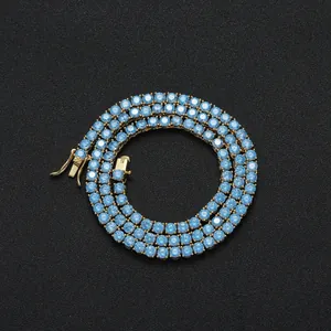 Macro detail of 4mm blue zircon tennis chain with gold plating and secure clasp closure