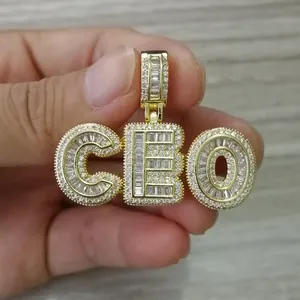 Macro shot of iced-out CEO gold letter pendant with micro-pave cubic zirconia crystals