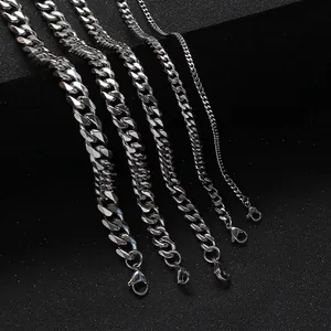 Detail of five stainless steel Cuban link chains in various widths with lobster clasps