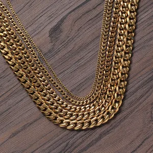 Multiple sizes of golden Cuban link necklaces displayed on a rustic wood background