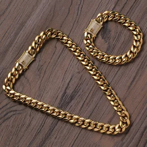 14mm golden Cuban link chain set with iced-out buckle on dark walnut background