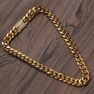 Macro shot of 14mm golden Cuban link necklace with a sparkling diamond-set box clasp