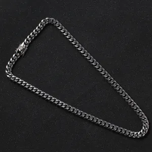 Macro detail of high-polished stainless steel Cuban link chain with secure box clasp closure