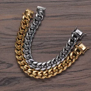 Polished gold and silver Cuban link bracelets in a classic hip-hop style on wood