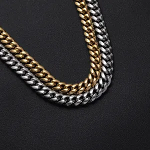 Detail of high-polished gold and silver Cuban link chains on a black textured background