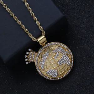 Close-up of golden crown earth pendant with white zircons on twist rope chain