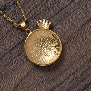 Golden stainless steel crown globe pendant necklace on vintage wood background