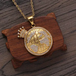Golden crown earth pendant necklace with crystals on a wooden background