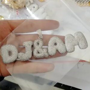 Close-up of DJ&AM bubble letter pendant with micro-pave white cubic zirconia stones