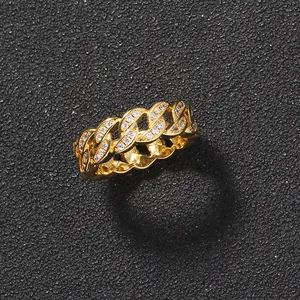Macro shot of gold plated hip hop Cuban link ring with pavé set white zircon stones