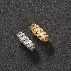 Macro view of gold and silver cuban link rings with micro-paved cubic zirconia