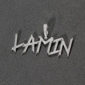 Macro detail of iced out silver letter pendant LAMIN with micro-pave zircons
