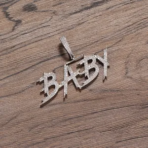 Macro detail of silver hip hop pendant with cubic zirconia micro-pave baby letters