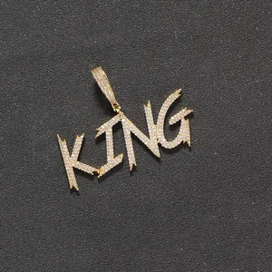 Close-up of KING hip hop pendant with micro-pave white zircon inlay on silver metal base