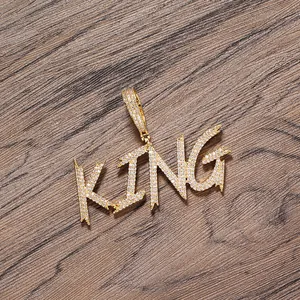 Detailed shot of gold-plated KING letter pendant with micro-paved sparkling zircon stones